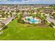 View of the inviting community pool, clubhouse, and lush landscaping in a well-maintained neighborhood at 1325 Custer Bayou St, Ruskin, FL 33570