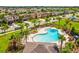 Gorgeous community pool area with palm trees and plenty of lounge chairs for relaxing by the sparkling water at 1325 Custer Bayou St, Ruskin, FL 33570