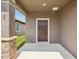 Covered front entry featuring stone accents and a dark wood front door with transom window at 1325 Custer Bayou St, Ruskin, FL 33570