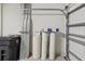 Spacious garage interior featuring a water softener, shelving, and a roll-up door at 1325 Custer Bayou St, Ruskin, FL 33570