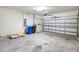 Large garage with ample space, cement floor, and a roll-up door, perfect for storage at 1325 Custer Bayou St, Ruskin, FL 33570