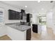 Contemporary kitchen featuring dark wood cabinets, granite countertops, and a center island at 1325 Custer Bayou St, Ruskin, FL 33570