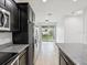 Stylish kitchen equipped with stainless steel appliances, granite counters, and backyard access at 1325 Custer Bayou St, Ruskin, FL 33570