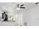 Spacious living space featuring neutral paint, modern ceiling fan, and a pass-through to the kitchen at 1325 Custer Bayou St, Ruskin, FL 33570
