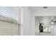 Bright, neutral living space featuring large windows, sleek ceiling fan, and a seamless flow to the kitchen at 1325 Custer Bayou St, Ruskin, FL 33570