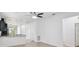Open-concept living area with hardwood floors, neutral walls, and a stylish ceiling fan fixture at 1325 Custer Bayou St, Ruskin, FL 33570