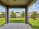 Covered patio with brick pavers overlooking a green backyard and fenced view at 1325 Custer Bayou St, Ruskin, FL 33570