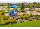 Community playground featuring a blue slide, swings and shade structure in a well-maintained area at 1325 Custer Bayou St, Ruskin, FL 33570