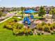 Playground with slides, swings, and a protective shade, amidst well-kept lawns and community homes at 1325 Custer Bayou St, Ruskin, FL 33570