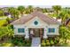 A charming pool house sits adjacent to the pool area with bright accents, and mature landscaping at 1325 Custer Bayou St, Ruskin, FL 33570