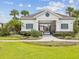 Community pool house with blue shutters surrounded by lush greenery and providing a relaxing atmosphere at 1325 Custer Bayou St, Ruskin, FL 33570