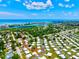 Stunning aerial view of the community showcasing proximity to the water, lush landscaping, and well-maintained homes at 14230 86Th Ter, Seminole, FL 33776