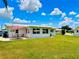 Exterior view of home with a well-maintained lawn and patio area at 14230 86Th Ter, Seminole, FL 33776
