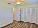 Bedroom with ceiling fan, wood flooring, and closets at 14230 86Th Ter, Seminole, FL 33776