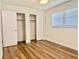 Bedroom with wood flooring, closet, and window at 14230 86Th Ter, Seminole, FL 33776