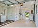 Spacious garage featuring utility sink, hot water heater, washer, dryer, and access to backyard at 14230 86Th Ter, Seminole, FL 33776