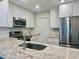 Beautiful kitchen showcases granite counters, stainless steel appliances and ample white cabinets at 14230 86Th Ter, Seminole, FL 33776