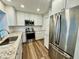 Modern kitchen features stainless steel appliances, granite countertops, and white cabinetry at 14230 86Th Ter, Seminole, FL 33776