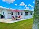 Cozy patio with outdoor seating and a striped umbrella, perfect for relaxing in the sun at 14230 86Th Ter, Seminole, FL 33776