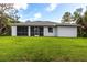 Spacious backyard with a screened-in porch, ideal for relaxing and enjoying the outdoors in comfort at 14422 Chamberlain Blvd, Port Charlotte, FL 33953
