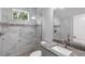 Modern bathroom featuring marble tile, granite vanity, and a decorative shower at 14422 Chamberlain Blvd, Port Charlotte, FL 33953
