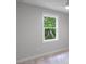 Bright bedroom with large window overlooking green trees, and neutral walls at 14422 Chamberlain Blvd, Port Charlotte, FL 33953