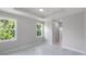 Spacious bedroom featuring tray ceiling, large windows, and marble flooring at 14422 Chamberlain Blvd, Port Charlotte, FL 33953