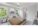 Main bedroom featuring a tray ceiling, large windows, and ensuite bathroom at 14422 Chamberlain Blvd, Port Charlotte, FL 33953
