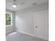Cozy bedroom with a window, gray carpet, and a neutral color scheme at 14422 Chamberlain Blvd, Port Charlotte, FL 33953