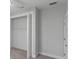 Bright closet featuring neutral walls, carpet, and a bi-fold door at 14422 Chamberlain Blvd, Port Charlotte, FL 33953