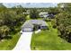 Stunning aerial view of the home showcasing its manicured lawn, paved driveway, and attractive landscaping at 14422 Chamberlain Blvd, Port Charlotte, FL 33953