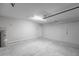 Spacious garage featuring concrete flooring, neutral walls, and a water heater at 14422 Chamberlain Blvd, Port Charlotte, FL 33953