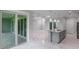 Open-concept kitchen featuring marble floors, gray cabinets, and stainless steel appliances at 14422 Chamberlain Blvd, Port Charlotte, FL 33953
