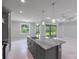Kitchen with marble island, gray cabinets, stainless steel appliances and open concept floor plan at 14422 Chamberlain Blvd, Port Charlotte, FL 33953