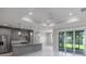 Modern open-concept kitchen featuring stainless steel appliances, gray cabinets and marble countertops and backsplash at 14422 Chamberlain Blvd, Port Charlotte, FL 33953