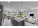 Modern kitchen with island, breakfast nook, living room and white marble floors at 14422 Chamberlain Blvd, Port Charlotte, FL 33953