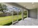 Screened lanai offering outdoor living with a view of the grassy backyard at 14422 Chamberlain Blvd, Port Charlotte, FL 33953