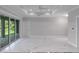 Spacious living room with marble flooring, tray ceilings and a sliding door for seamless indoor-outdoor living at 14422 Chamberlain Blvd, Port Charlotte, FL 33953