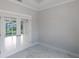 An empty, well-lit office space with tiled floors and stylish French doors at 14422 Chamberlain Blvd, Port Charlotte, FL 33953