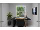 Brightly lit home office with computer setup and view to the outdoors at 14422 Chamberlain Blvd, Port Charlotte, FL 33953
