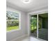 Bright sunroom with marble floors, access to the backyard, and a screened in patio at 14422 Chamberlain Blvd, Port Charlotte, FL 33953