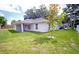 Well-manicured backyard with a covered patio, perfect for outdoor gatherings and relaxation at 1536 Palmetto St, Clearwater, FL 33755