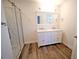 Bathroom featuring double vanity, a glass shower, and wood-look flooring at 1536 Palmetto St, Clearwater, FL 33755