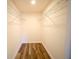 Walk-in closet with wood-look flooring and wire shelving for optimal storage at 1536 Palmetto St, Clearwater, FL 33755