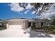Charming single-story home with a well-maintained front yard and an attached two-car garage at 1536 Palmetto St, Clearwater, FL 33755