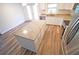 Kitchen island features granite countertop and drawers paired with stainless steel appliances and white cabinets at 1536 Palmetto St, Clearwater, FL 33755