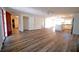 Spacious living room featuring wood flooring, a ceiling fan, and an open layout to the kitchen at 1536 Palmetto St, Clearwater, FL 33755