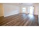 Bright living room featuring wood floors, a ceiling fan, and an open front door at 1536 Palmetto St, Clearwater, FL 33755