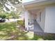 Inviting side porch with ample space, beautiful landscaping, and a glimpse of the surrounding neighborhood at 1536 Palmetto St, Clearwater, FL 33755