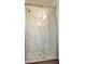 Close-up of a glass shower stall with marble-patterned walls and a sleek showerhead at 1536 Palmetto St, Clearwater, FL 33755